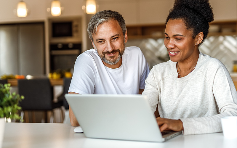 A diverse family working on a computer